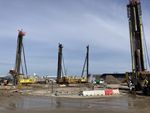 Picture shows 3 pile drivers for special civil engineering of Franki piles; the pile drivers stand on muddy ground